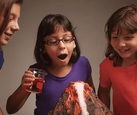 Students watching a model volcano experiment